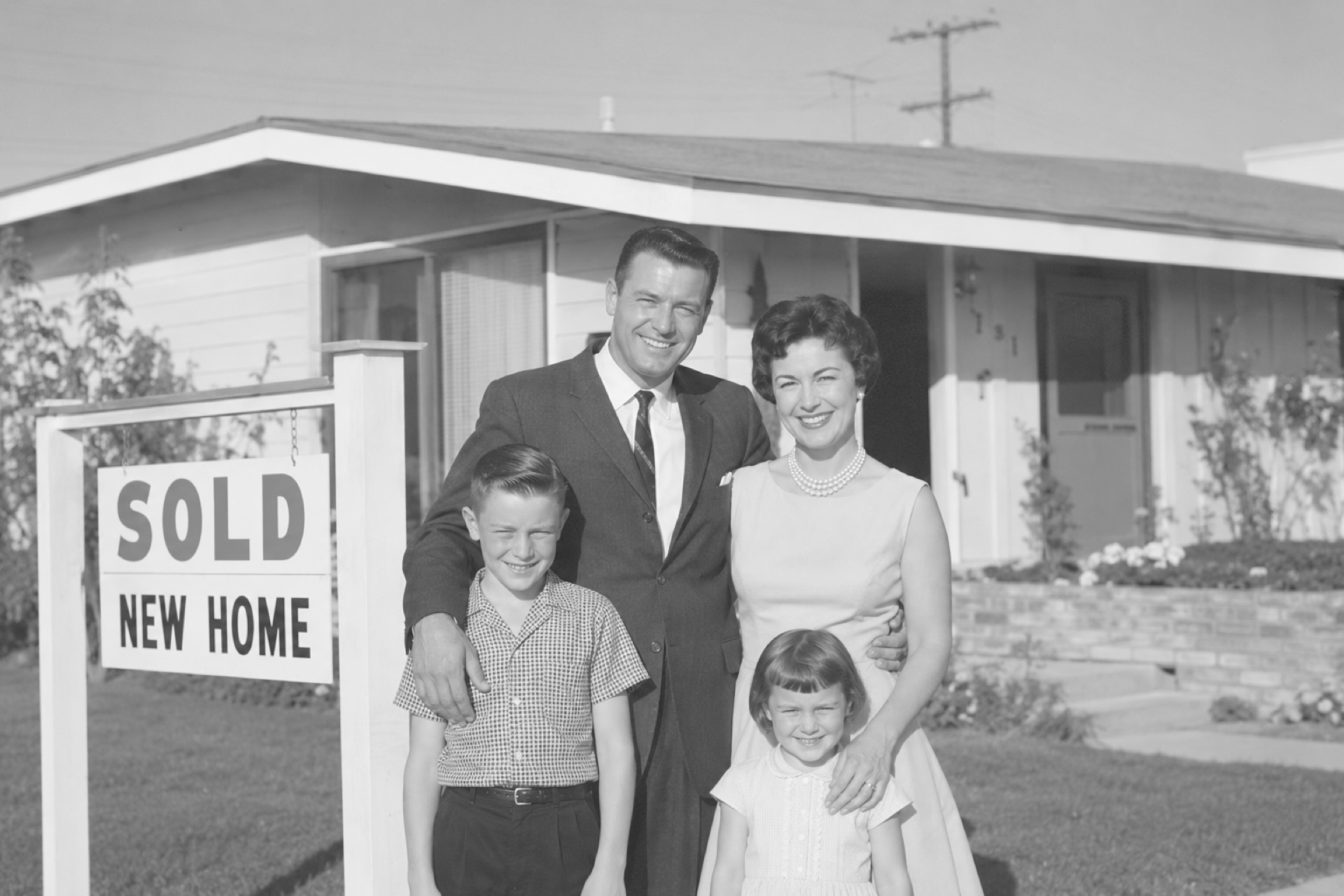 A family in front of their new home in the 1960s, around the time California Title Company opened its doors